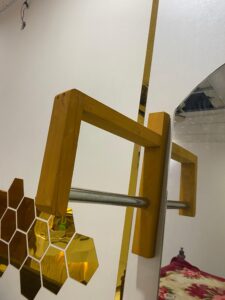 Wall mounted hanger designed for hanging dresses – sturdy, space-saving solution with a sleek design for organized clothing storage.